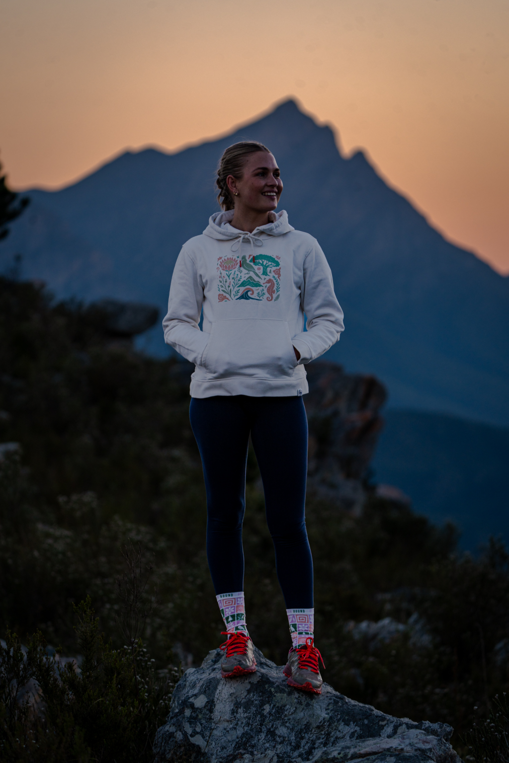 Woman in an Outeniqua Bound hoodie in the Outeniqua mountains
