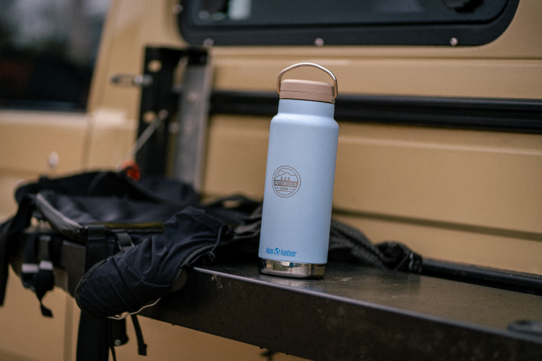 Klean Kanteen water bottle and camping gear in the back of an overland vehicle