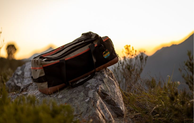 Outeniqua Bound bag resting on a rock at golden hour